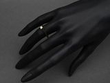 a close up of a person ' s hand with a ring on it