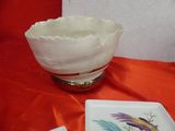 a bowl and a plate on a table with a red cloth