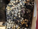 a box full of assorted jewelry on a table