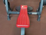 a red bench in the middle of a gym room