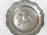 a silver plate with a coat of arms on it