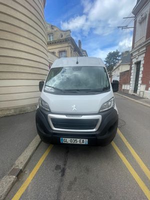 the van is parked on the side of the road in front of a building