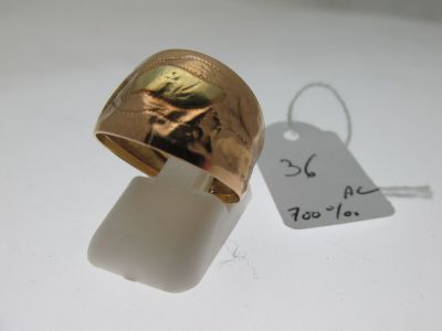 a gold ring with a picture of a woman on it