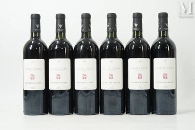 six bottles of wine are lined up in a row on a table