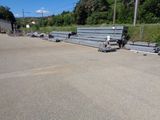a lot of steel benches sitting in a parking lot