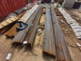 several steel rods are stacked on top of each other in a warehouse