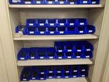 the shelves are full of blue bins in the garage