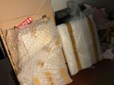 a box of toilet paper sitting on the floor next to a pile of toilet paper