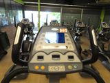 many tread machines in the gym with a monitor on them