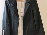 jacket hanging on a hanger on a wall in a room