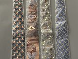 four ties are lined up in a row on a gray surface