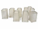 a group of white vases sitting on a white surface
