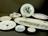 many plates and bowls sitting on a table