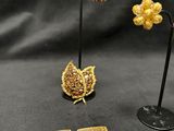 two pairs of gold and diamond earrings and a pair of earrings