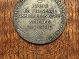 a close up of a metal coin on a wooden surface
