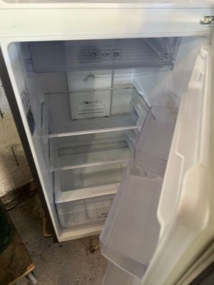 an open refrigerator that is sitting in the kitchen