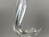une sculpture en verre représentant un oiseau, posée sur un socle