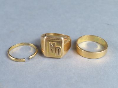 two gold rings and a gold ring with the letter m on it