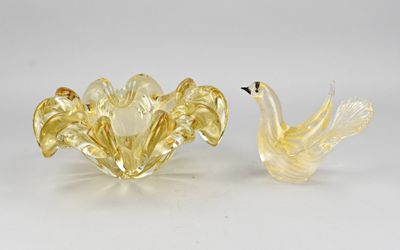 two yellow glass birds sitting next to each other on a white surface