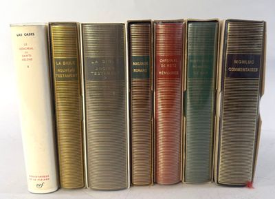 several books are lined up in a row on a white surface