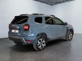 the rear end of a blue suv parked in a garage