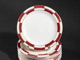 several red and white plates stacked on top of each other on a black surface
