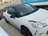 a small white car parked on the side of the road