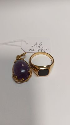 a close up of two rings on a white surface with a tag