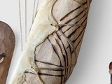 a wooden object hanging on the wall next to other items