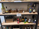bottles of alcohol are on shelves in a liquor store