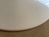 a white bowl sitting on the floor next to a window