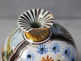 a vase with a flower decoration on it on a table