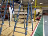 many ladders that are sitting in the middle of a room