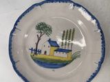 a plate with a picture of a house on it and a plate with a picture of a house on it