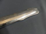 a knife that is laying on a black surface