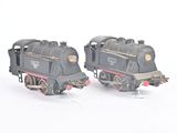 two toy trains sitting side by side on a white surface