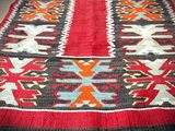 an image of a red and black rug on the floor