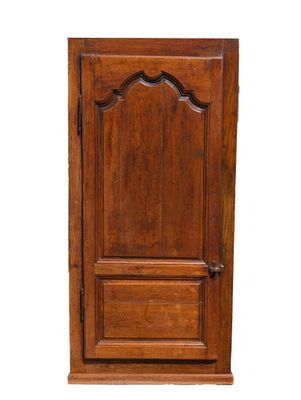 an old wooden cabinet with a door on top of it