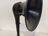 an old fashioned black and silver speaker sitting on top of a white table