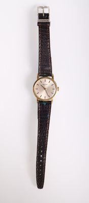 an image of a wrist watch on a white surface with a white background