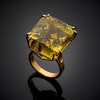 a yellow diamond ring on a black surface