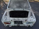 an old car that is parked on the side of the road