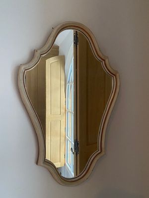 a mirror on the wall above a sink in a bathroom