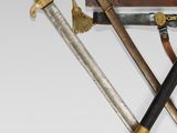 two swords and a plaque on a wall with a certificate