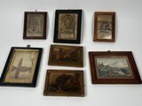 many framed pictures hanging on the wall of a room