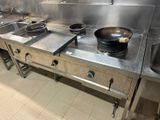 stainless steel counter top in a commercial kitchen with a frying pan on the burner