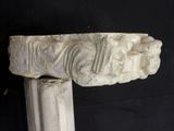 a stone sculpture of a head on top of a pillar