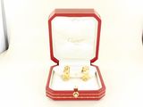 a red box with a pair of gold rings in it
