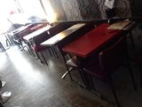 tables and chairs are lined up in a room with a wallpapered wall