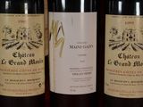 three bottles of wine sitting on a table next to each other